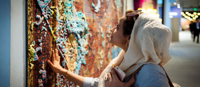 Woman enjoying a piece of art during dubai design week