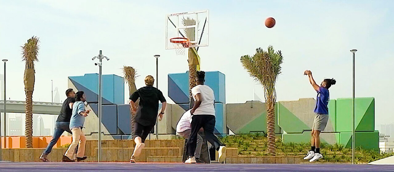 People playing a game of basketball in d3's recreational community the block