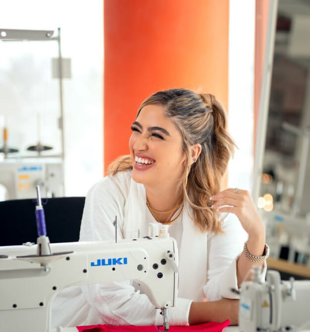 woman smiling while working at Dubai Institute of Design and Innovation