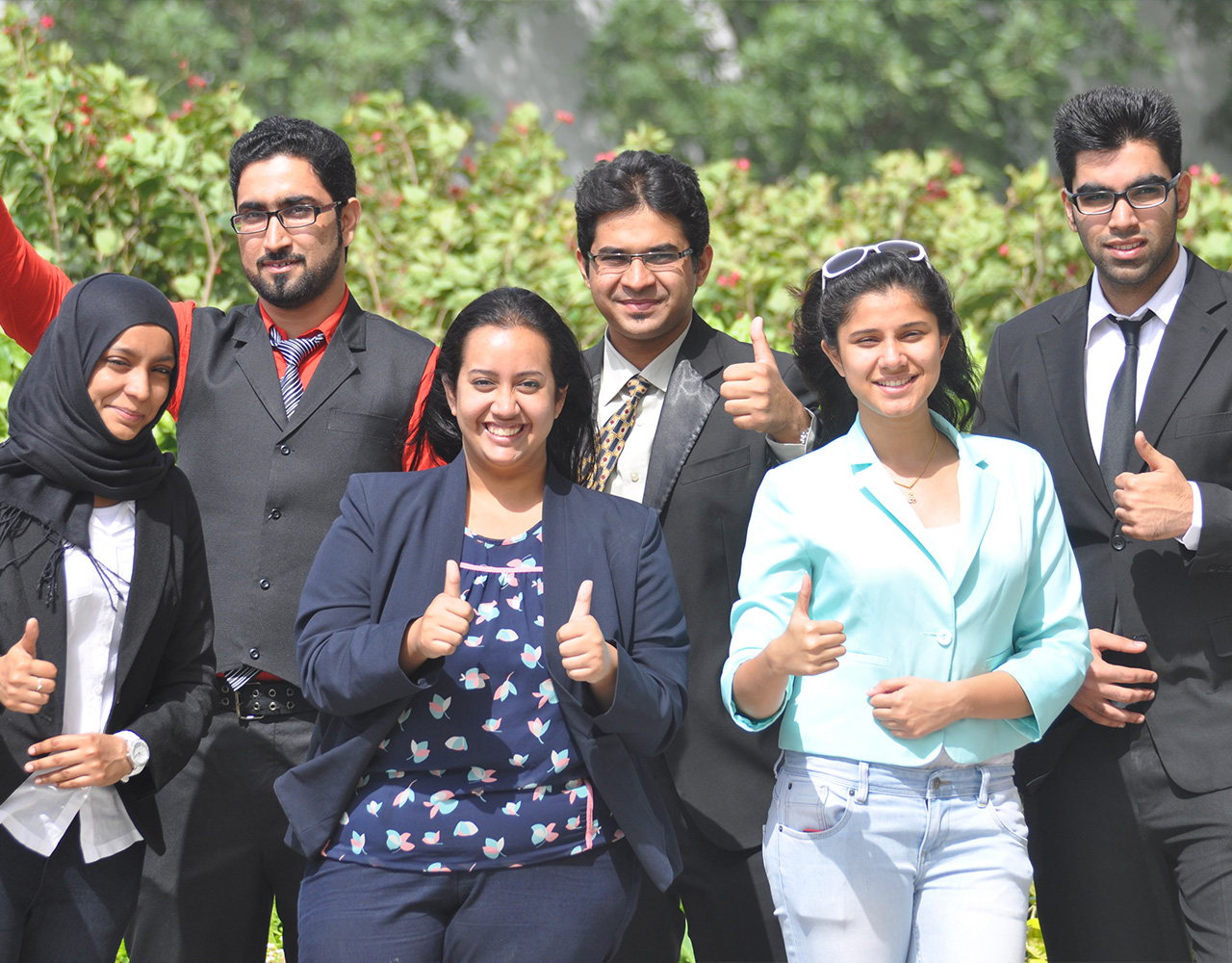 Six Indian students posing for a picture at campus