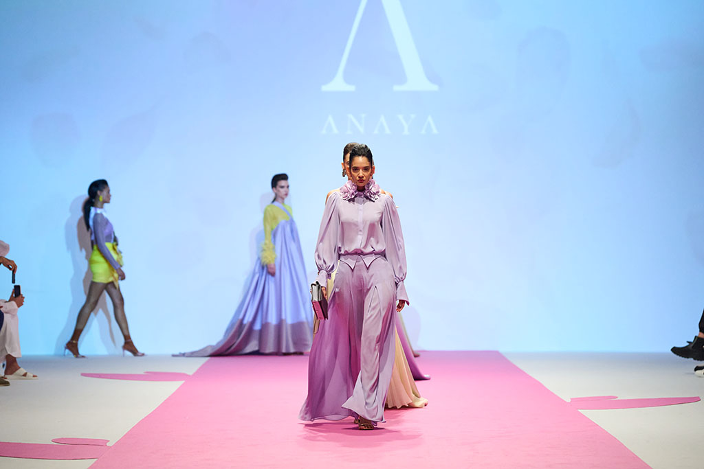 Three fashion models on Dubai fashion week runway presenting Anaya haute couture collection
