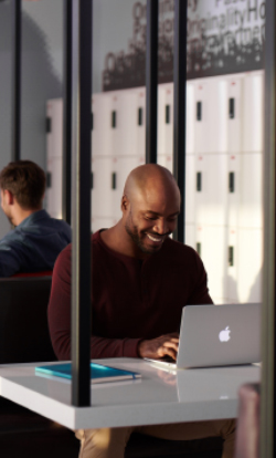 A happy freelancer working on his laptop at one of our spaces in Dubai