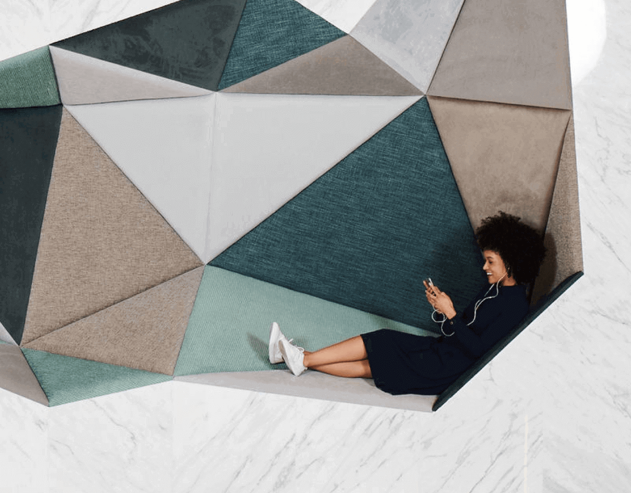  A woman listening to music on her phone at Dubai Outsource City