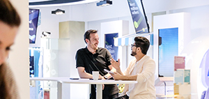 Two employees having a conversation at one of our spaces in Dubai Outsource City