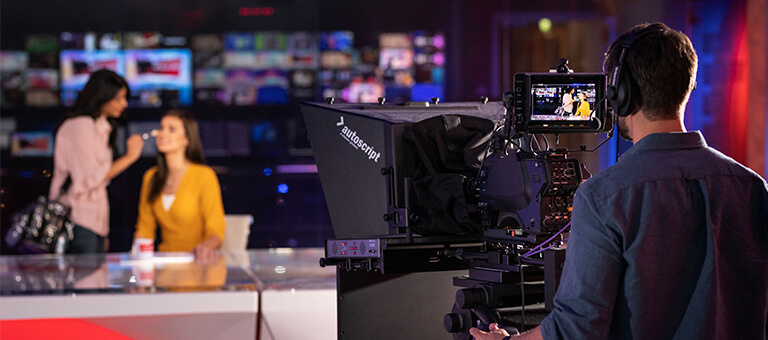 A woman getting a mid-shoot makeup touchup done, at Dubai Studio City